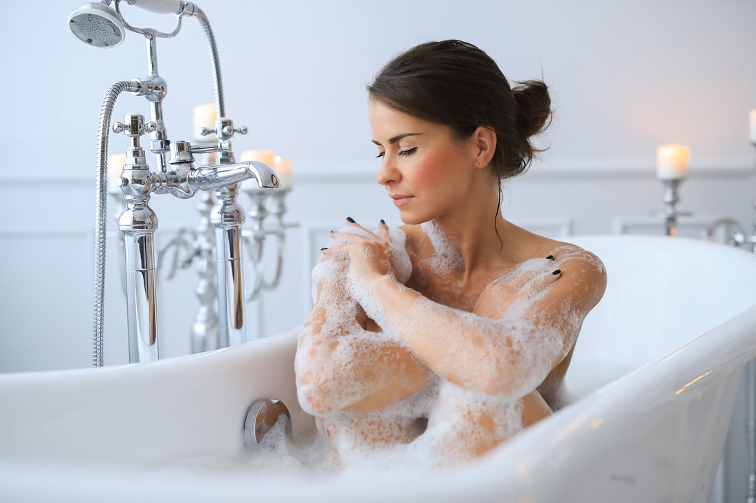 Woman bathing as part of a gentle body-cleansing and skin-longevity routine