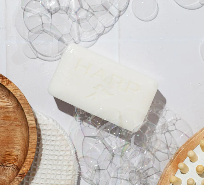 HARP cleansing bar surrounded by a rich creamy lather